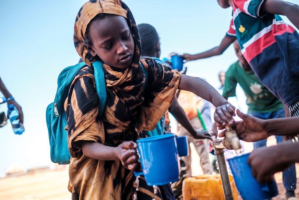 Children collect water at a school in the camp for internally displaced people of Farburo in the village of Adlale, near the city of Gode, Ethiopia, January 11, 2023. /CFP