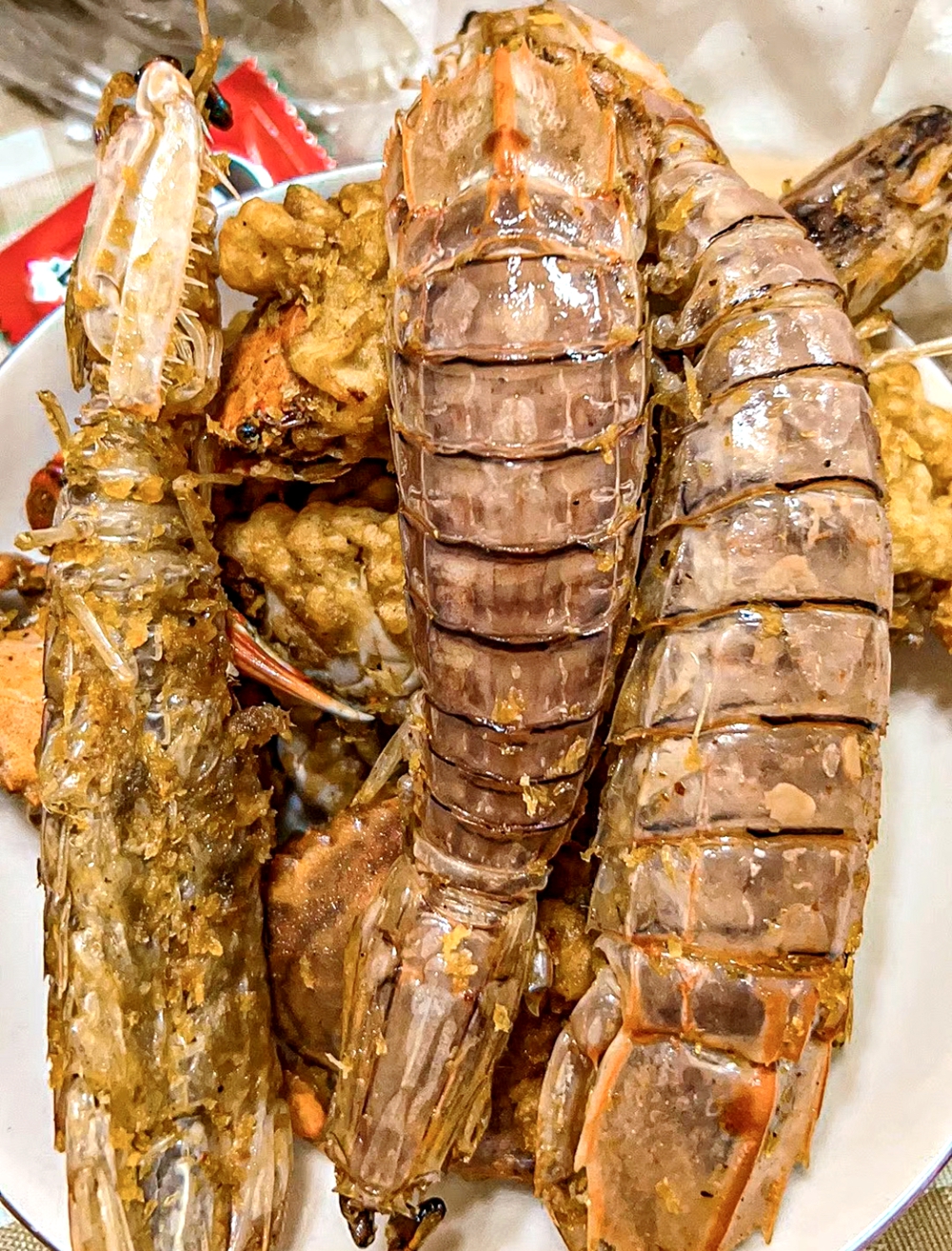 Fried mantis shrimps are seen in Haikou, south China's Hainan Province. /Photo provided to CGTN