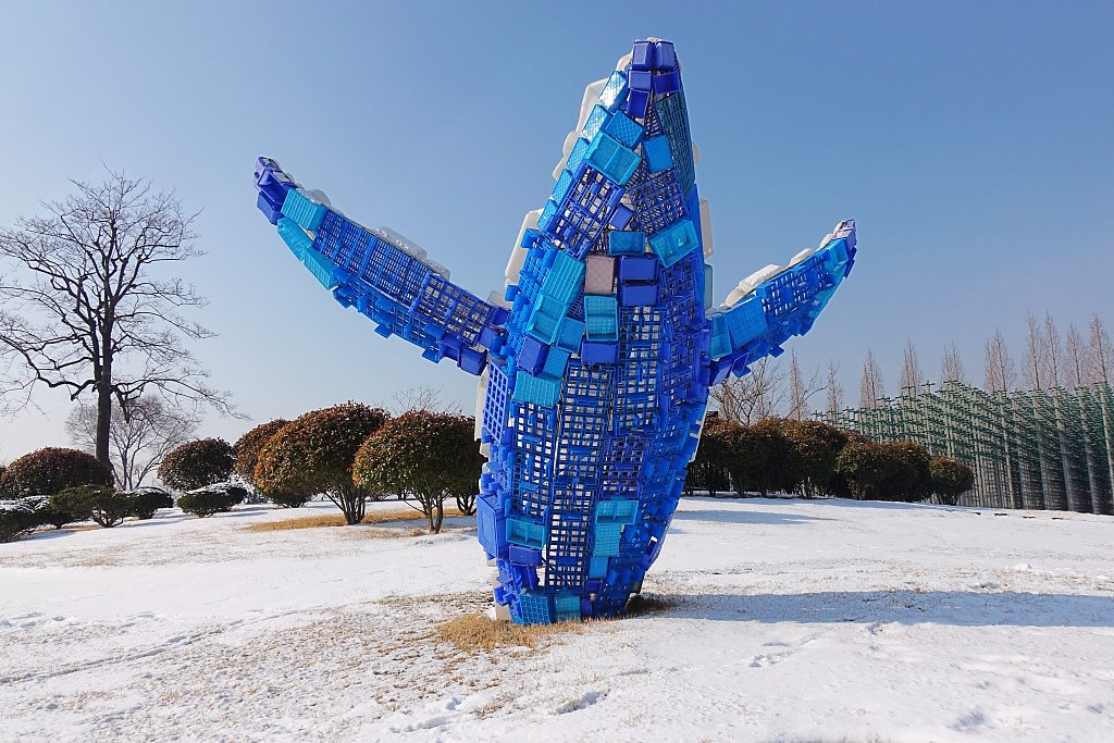 A statue featuring a whale made of 83 plastic products is displayed in a square in Qingdao, Shandong Province on February 25, 2024. /CFP