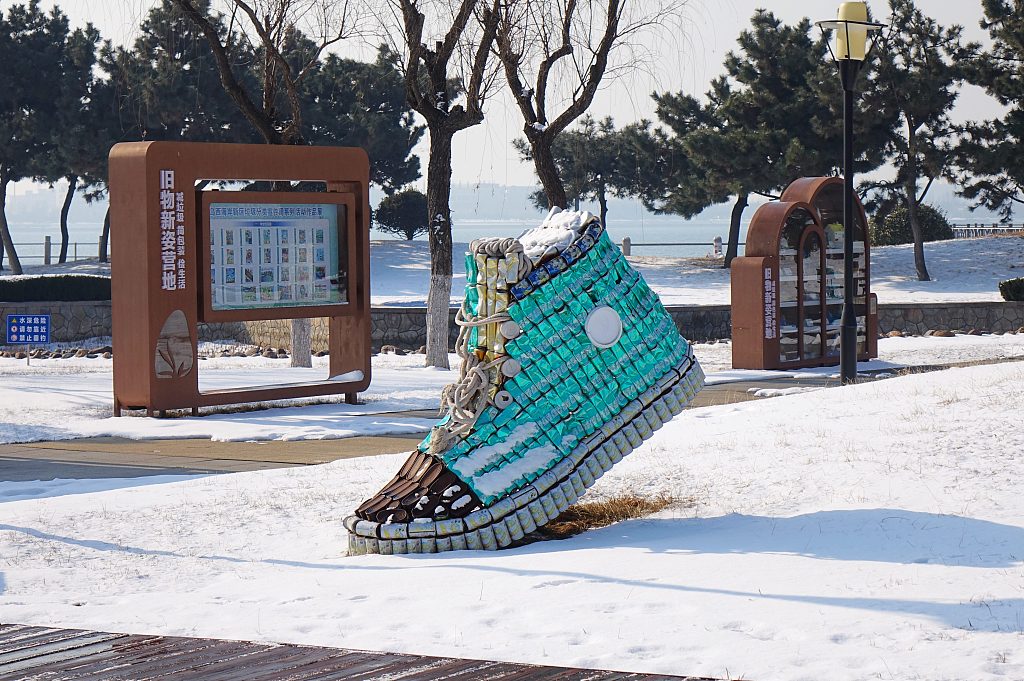 A statue of a shoe made of discarded drinks cans is displayed in a square in Qingdao, Shandong Province on February 25, 2024. /CFP