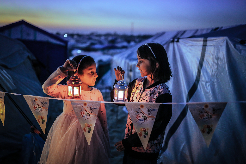 Palestinian children taking refuge in Tel al-Sultan region due to Israeli attacks decorate their tents with Ramadan lanterns and illuminate lights ahead of the holy Islamic fasting month of Ramadan in Rafah, Gaza on February 29, 2024. /CFP