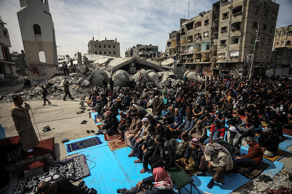 Palestinians attend Friday prayers near the ruins of a mosque destroyed in Israeli strikes, in Rafah in the southern Gaza Strip, March 1, 2024. /CFP