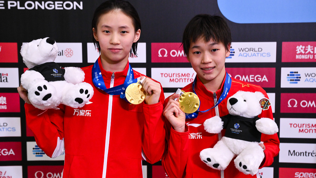Chen Yuxi (L) and Quan Hongchan celebrate winning the women's synchronized 10m platform at the diving World Cup in Montreal, Canada, March 2, 2024. /CFP