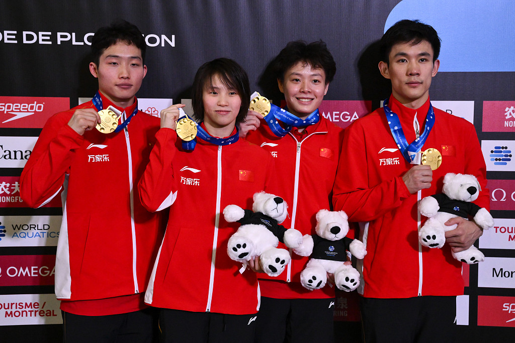 L-R: Wang Zongyuan, Chen Yuxi, Chen Yiwen and Yang Hao of China pose with the gold medals after winning the mixed 3-meter &10-meter team final at the World Aquatics Fiving World Cup in Montreal, Canada, March 1, 2024. /CFP