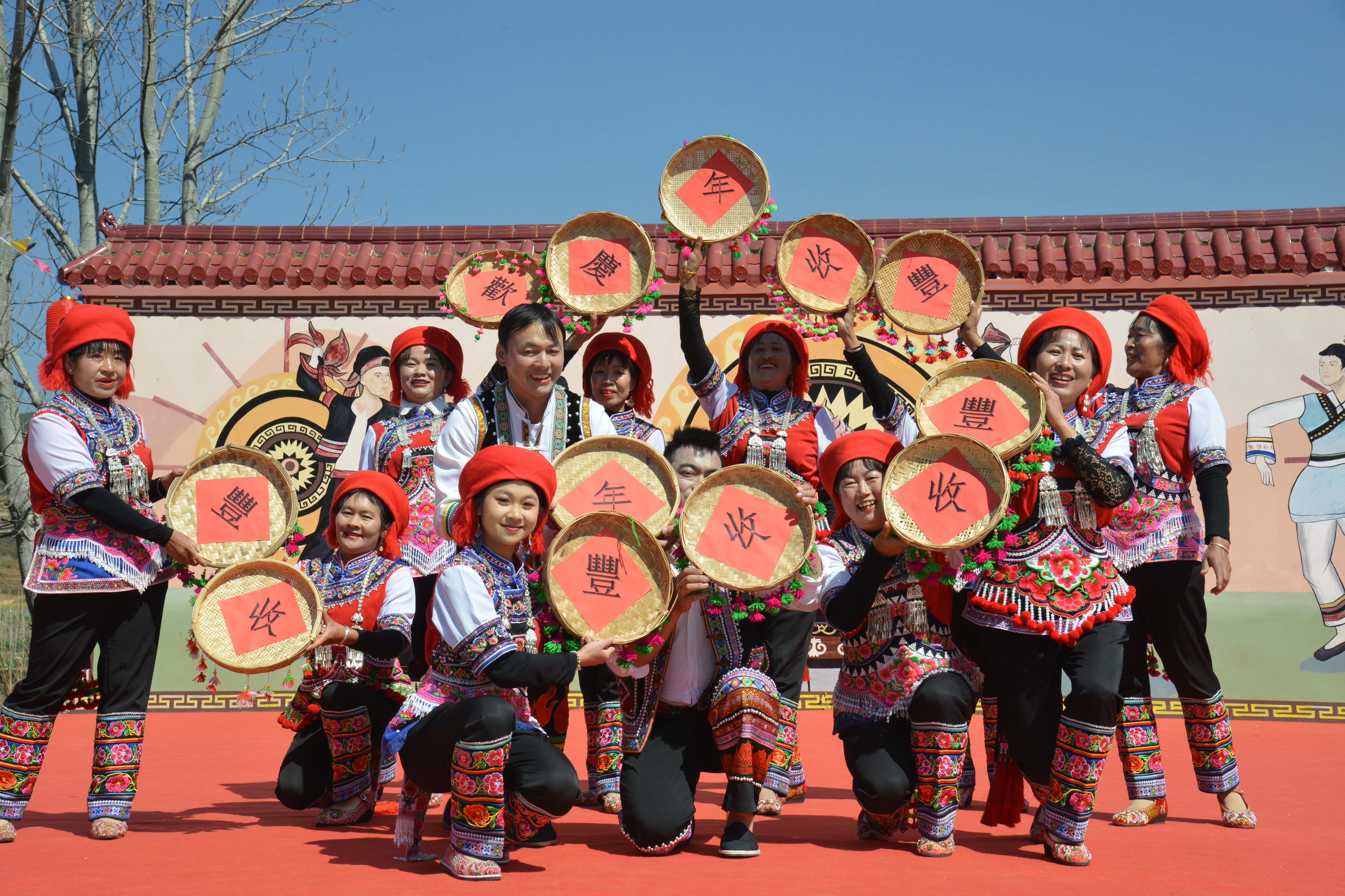 Yi villagers pose after performing a dance to celebrate the harvest at the third Rapeseed Flower Festival in Xiangshui Village, in the Jinning District of Kunming, southwest China's Yunnan Province on March 2, 2024. /IC 
