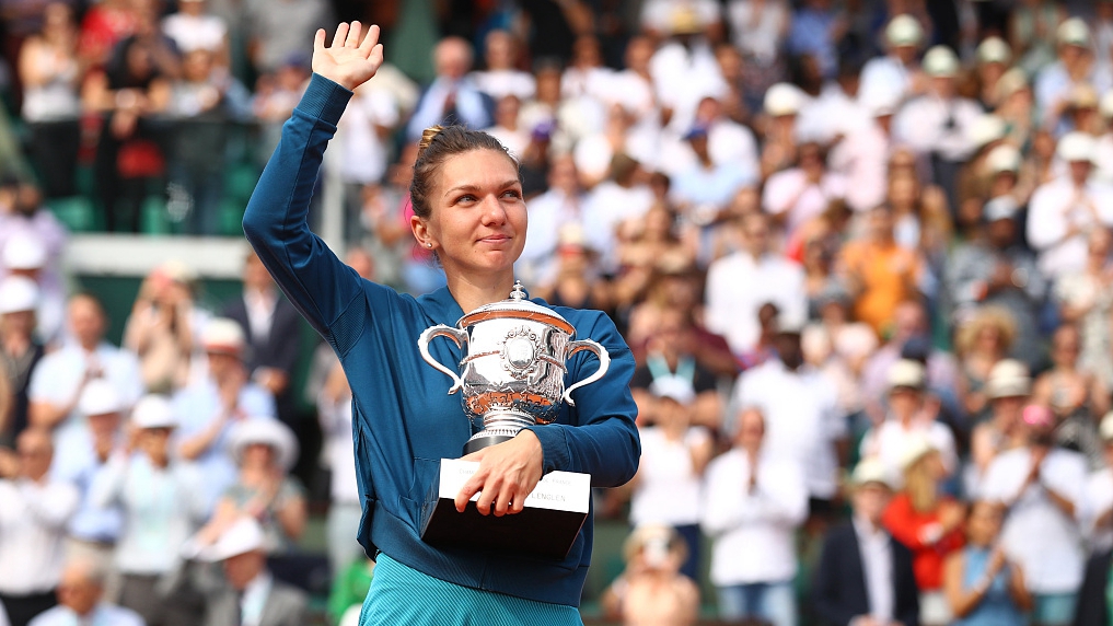 Simona Halep of Romania holds the trophy as she celebrates women's singles final win of the French Open at Roland Garros in Paris, France, June 9, 2018. /CFP