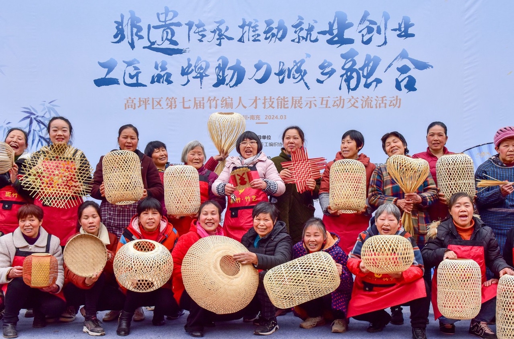 Women showcase woven bamboo items in Nanchong, Sichuan Province, March 5, 2024. /IC