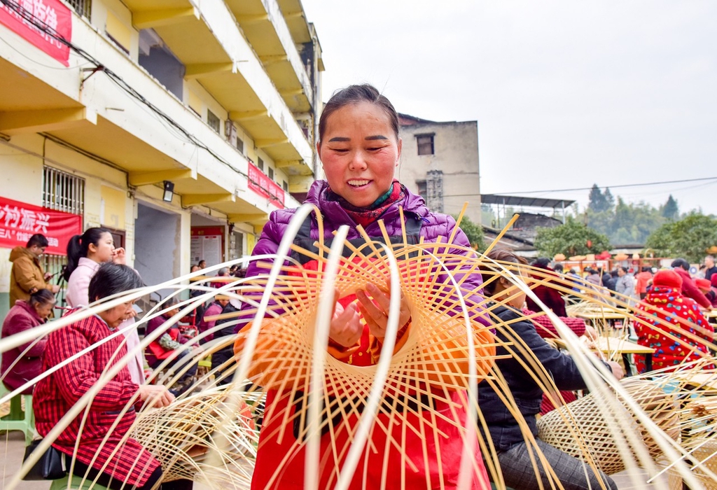 A woman weaves bamboo in Nanchong, Sichuan Province, March 5, 2024. /IC