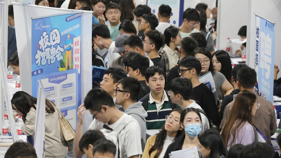 College graduates are seen at a job fair in Shanghai University of Engineering Science in east China's Shanghai, October 16, 2023. /Xinhua