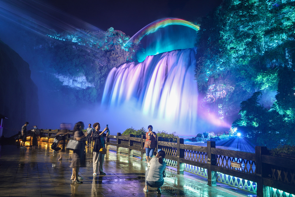 Visitors enjoy a 3D light show at the Huangguoshu Waterfall, one of the largest waterfalls in China, in Anshun, Guizhou Province. /CFP