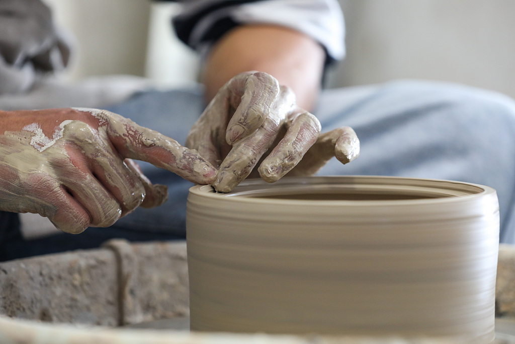 A file photo shows a close view of Zhang Shengbo making pottery in Yazhou Town, Guizhou Province. /CFP