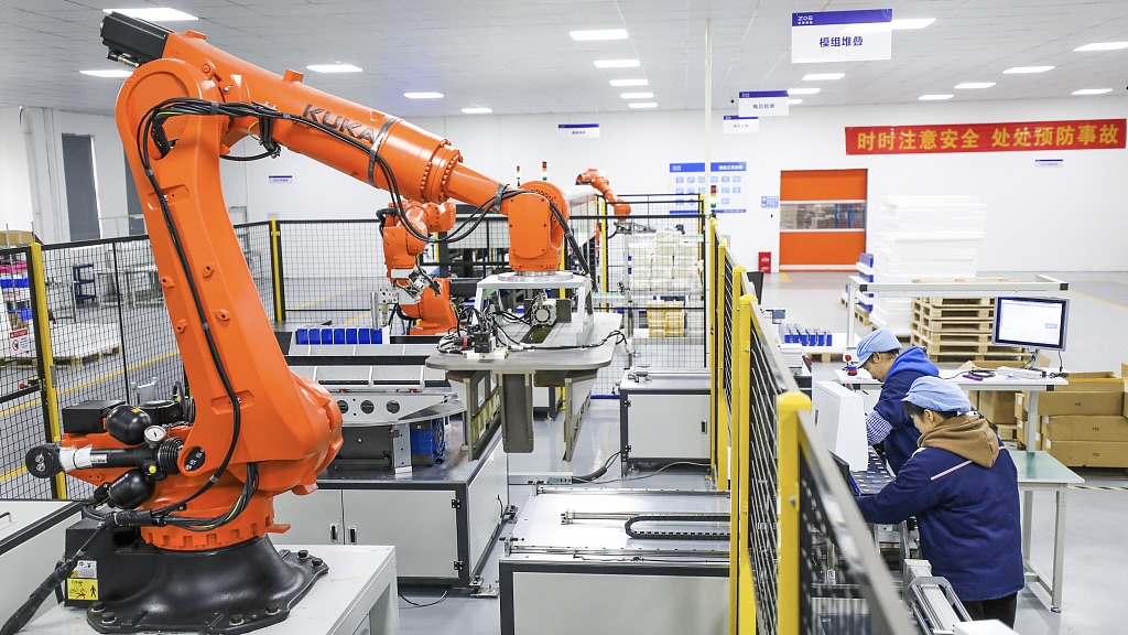 Workers operate robot arms in a factory in southeast China's Jiangxi Province, February 28, 2024. /CFP