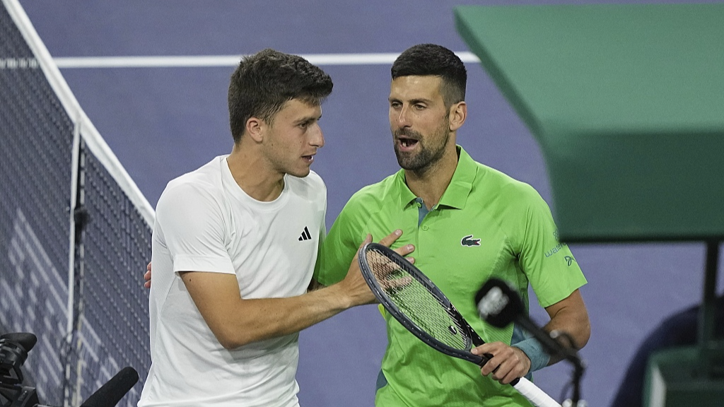 Luca Nardi (L) talks with Novak Djokovic after upsetting him in the third round of BNP Paribas Open in Indian Wells, U.S., March 11, 2024. /CFP