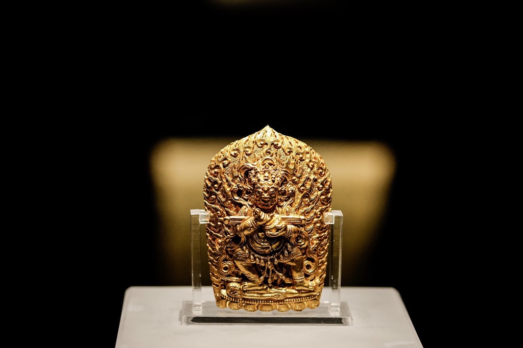 A gold Buddha figure forms part of an exhibition of relics from the tomb of Ming Dynasty Prince Liangzhuang, on display at Hubei Provincial Museum, Wuhan, Hubei Province, March 12, 2024. /IC