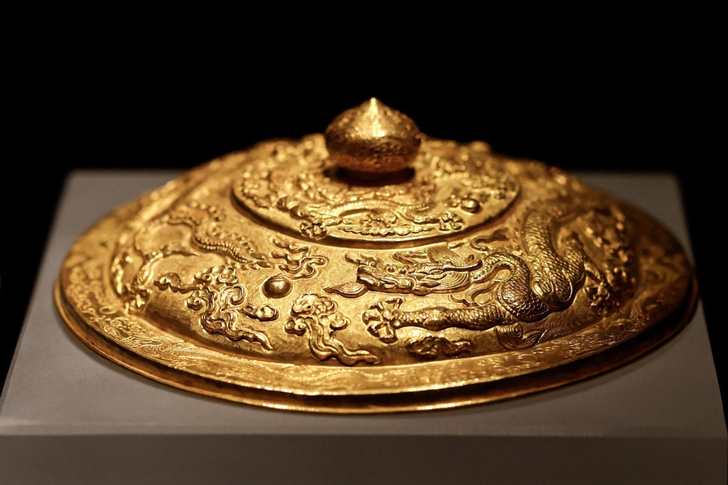 A golden bowl lid forms part of an exhibition of relics from the tomb of Ming Dynasty Prince Liangzhuang, on display at Hubei Provincial Museum, Wuhan, Hubei Province, March 12, 2024. /IC