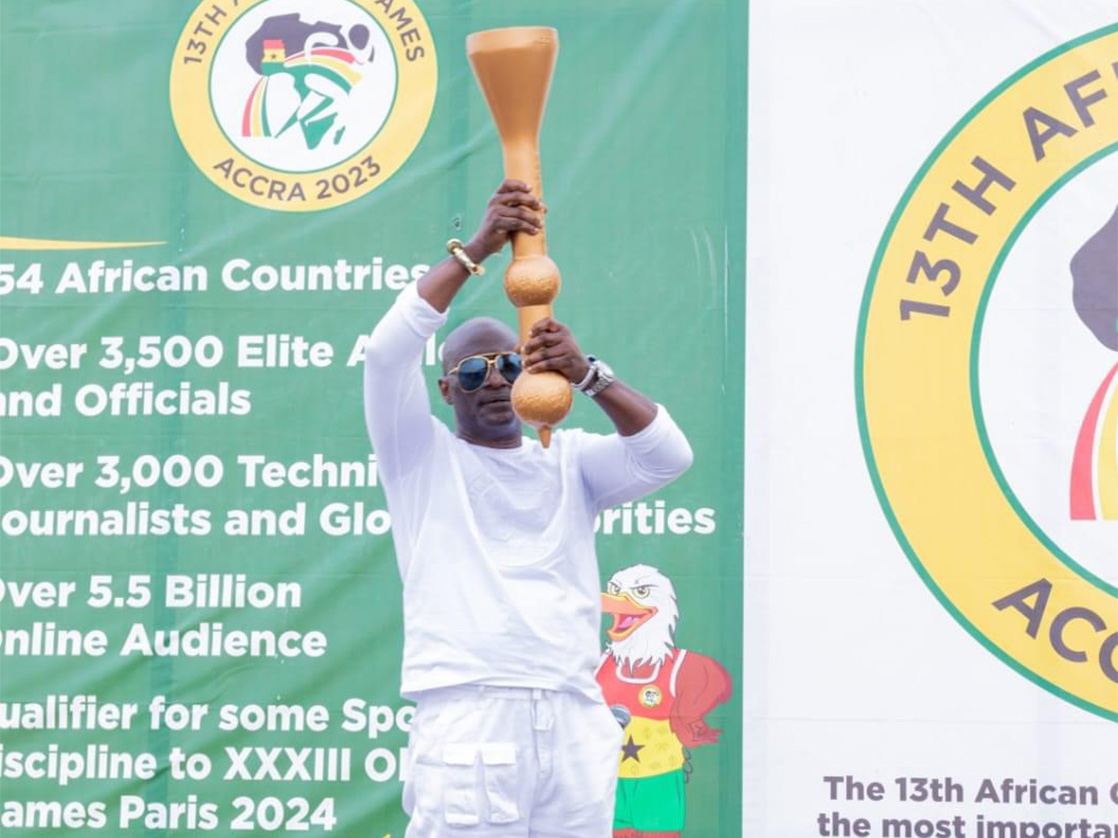 A man showcases the torch of the 13th African Games, which was made by Shandong Taishan Sports Equipment Co, Ltd. /taishansports.cn