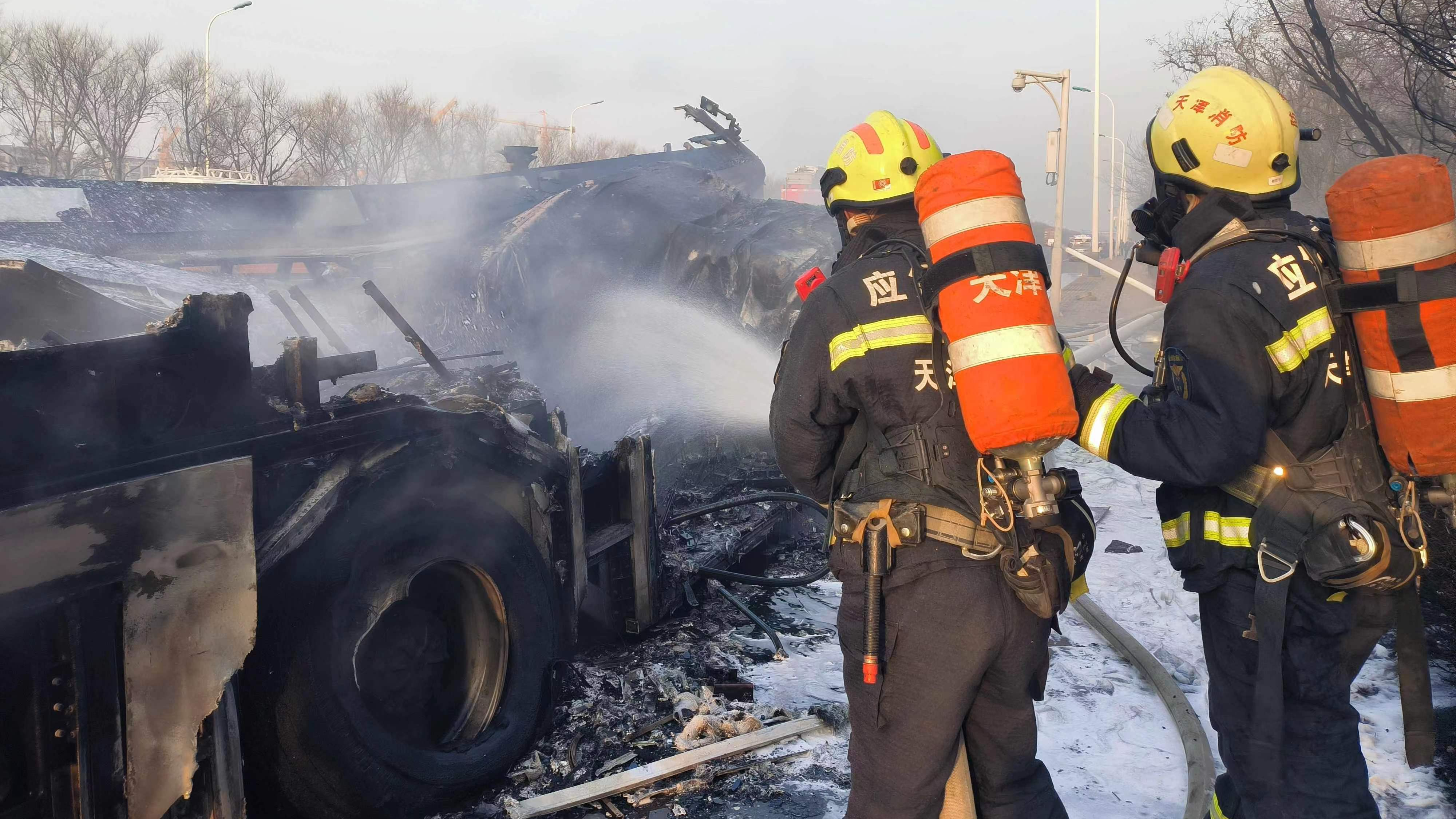 Firefighters extinguish a fire after a vehicle collision in north China's Tianjin Municipality, March 15, 2024. /CMG