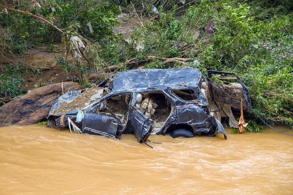 The wreckage of a car swept away by flash flooding is seen by a river bank in Pesisir Selatan Regency, West Sumatra, Indonesia, March 9, 2024. /CFP