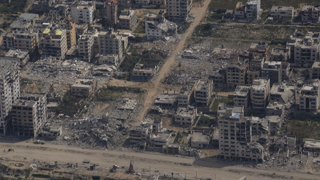 Destroyed buildings are seen through the window of an airplane as they stand in Gaza, March 14, 2024. /CFP