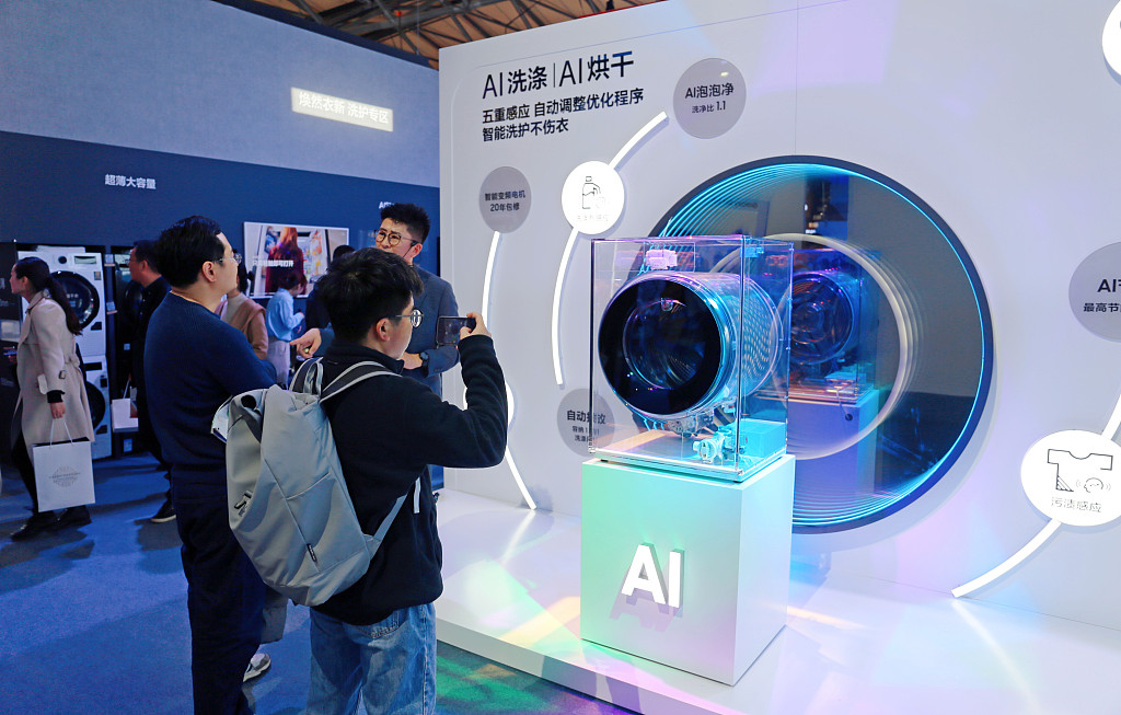 Visitors check out an AI washing machine at AWE2024, Shanghai Municipality, east China, March 14, 2024. /CFP