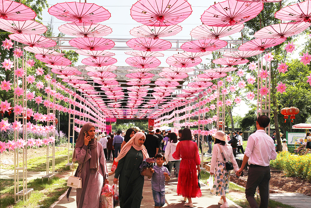Foreign tourists walk along a corridor at an agricultural attraction in Jinhua, east China's Zhejiang Province, May 1, 2023. /CFP