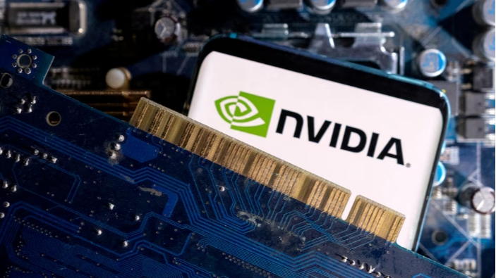 A smartphone with a displayed NVIDIA logo is placed on a computer motherboard in this illustration, March 6, 2023. /Reuters