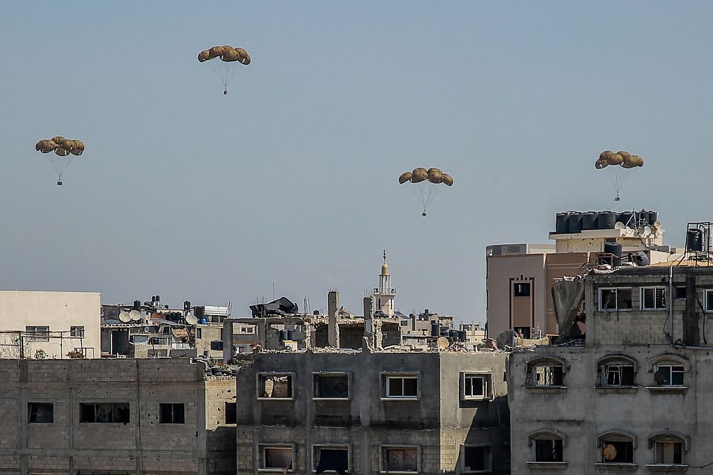 Humanitarian aid parcels attached to parachutes are airdropped from a military aircraft over Gaza City on March 20, 2024. /CFP