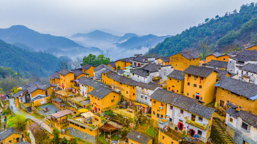 Adorned with mist and rolling hills, the Yangchan Tulou scenic area is pictured in Yangchan Village of Huangshan City, east China's Anhui Province on March 17, 2024. /CFP