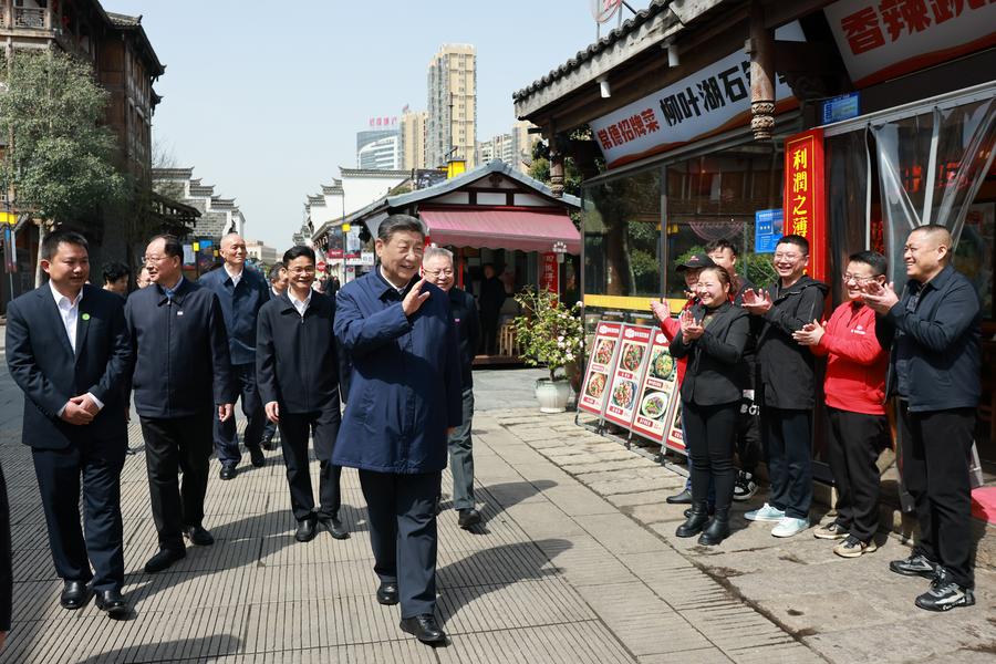 Chinese President Xi Jinping, also general secretary of the Communist Party of China Central Committee and chairman of the Central Military Commission, waves to citizens while visiting a cultural street in Changde, central China's Hunan Province, March 19, 2024. /Xinhua