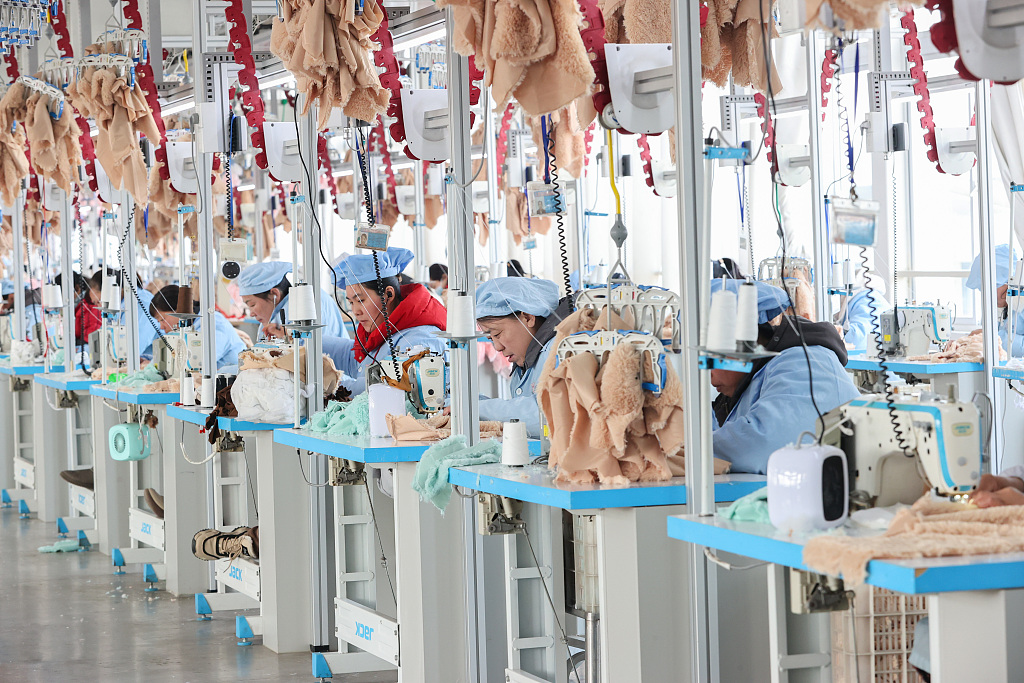 Workers at a toy company in Lianyungang, Jiangsu, sewing plush toys on March 24, 2024./CFP 