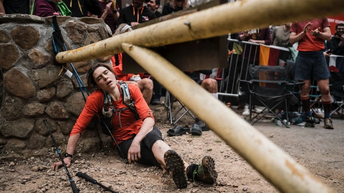 Jasmin Paris collapses onto the ground at the finish line after completing the Barkley Marathons in Frozen Head State Park, Tennessee, U.S., March 22. /Athletics Weekly