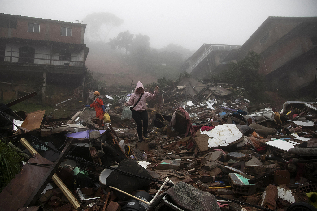 A resident walks through the debris caused by landslides due to heavy rains, in Petropolis, Rio de Janeiro, Brazil, March 23, 2024. /CFP