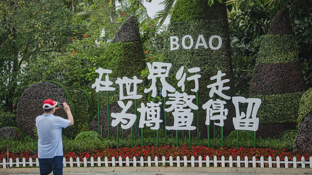 Tourist takes photos at the site of the Boao Forum for Asia in Qionghai City, south China's Hainan Province, March 19, 2024. /CFP