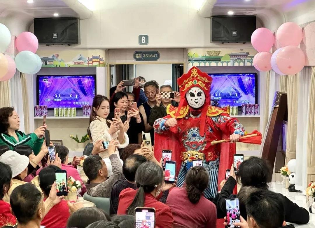 Passengers enjoy Sichuan Opera performances on the Shifang tourist train, which made its debut in Chengdu, Sichuan Province,  on March 22, 2024. /CMG
