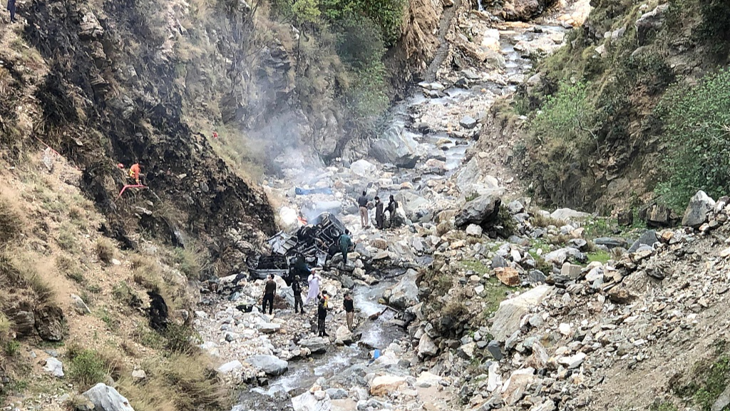 Security officials inspect the wreckage of a vehicle that was carrying Chinese nationals that plunged into a deep ravine off the mountainous Karakoram Highway after a suicide attack near Besham city in the Shangla district of Khyber Pakhtunkhwa province, March 26, 2024. /CFP
