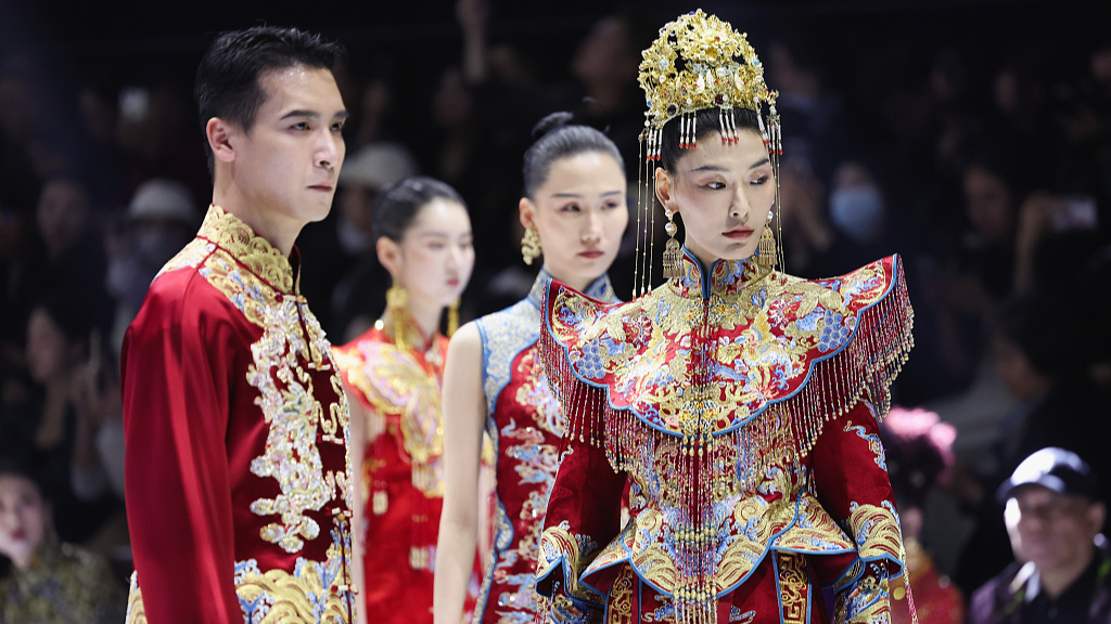 A photo taken on March 23, 2024 shows models wearing traditional Chinese wedding costumes at the opening ceremony of the AW24 China Fashion Week in Beijing, China. /CFP