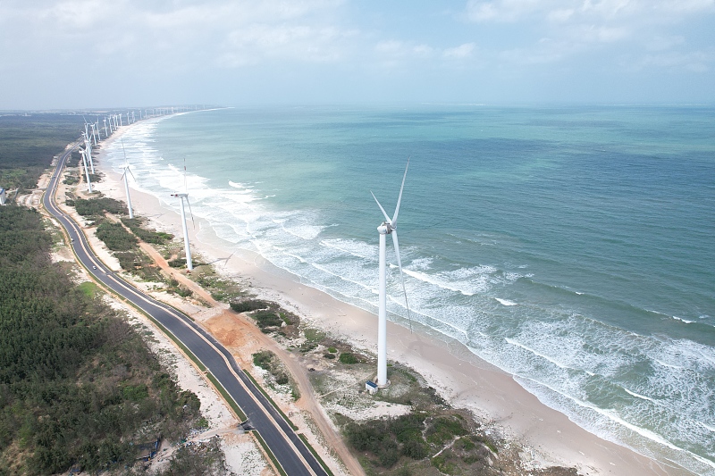 Wind turbines are seen along a coastal road in Wenchang City, south China's Hainan Province. /CFP