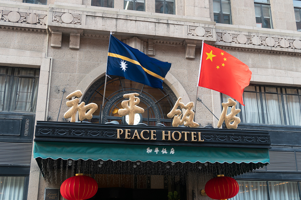 The national flags of China and Nauru hang above the door of Peace Hotel on Nanjing Road in Shanghai, east China, January 25, 2024. /CFP