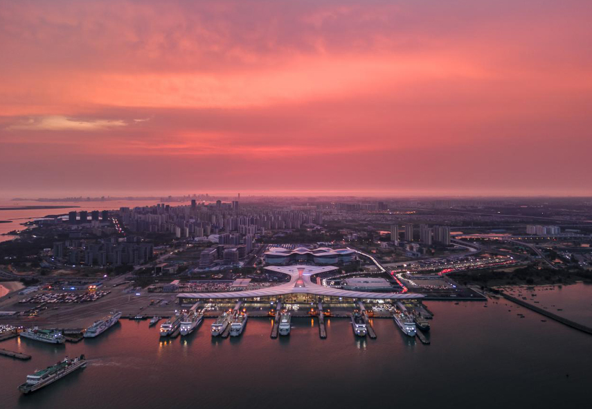 The rosy glow of dawn is seen over the Xinhai Port in Haikou, Hainan Province. /Photo provided to CGTN by Mao Zehao
