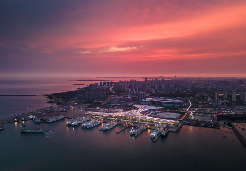 The rosy glow of dawn is seen over the Xinhai Port in Haikou, Hainan Province. /Photo provided to CGTN by Mao Zehao