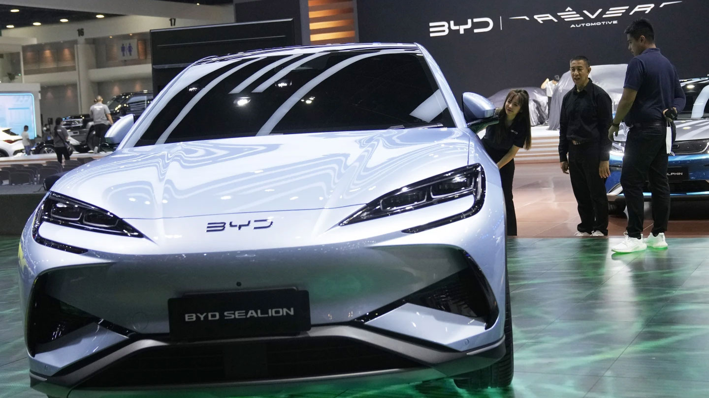 Visitors look at BYD's electric vehicle 