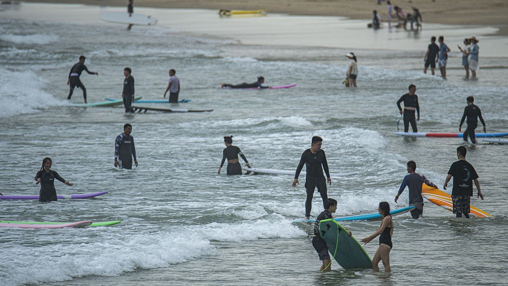 Tourists experience surfing at Riyue Bay, Wanning, south China's Hainan Province, September 5, 2023. /CFP 