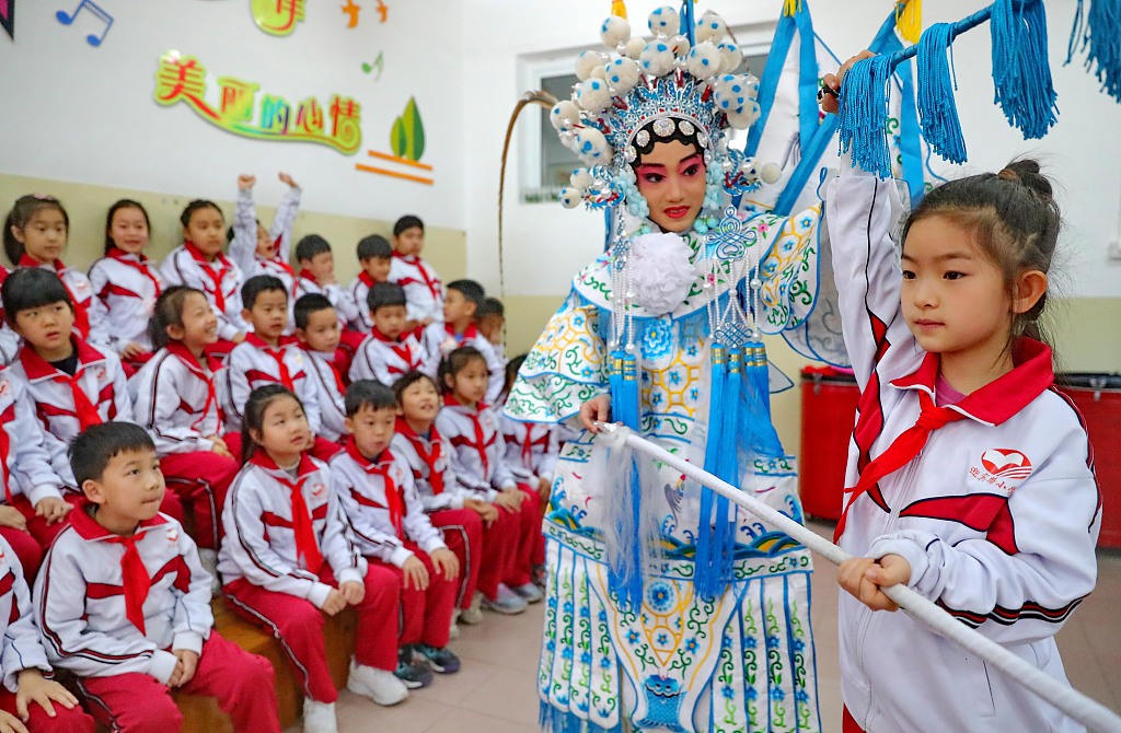 A pupil learns from a professional Peking Opera performer during a class in an elementary school in Qinhuangdao, Hebei Province, March 26, 2024. /CFP