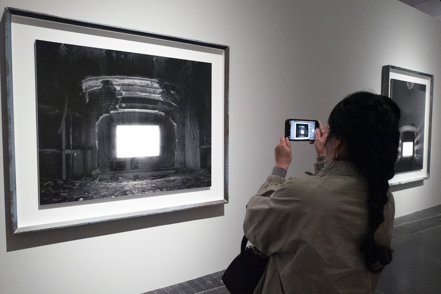 A visitor takes photos of one of Japanese artist Hiroshi Sugimoto's art pieces at UCCA Center for Contemporary Art in Beijing on March 26, 2024. /IC