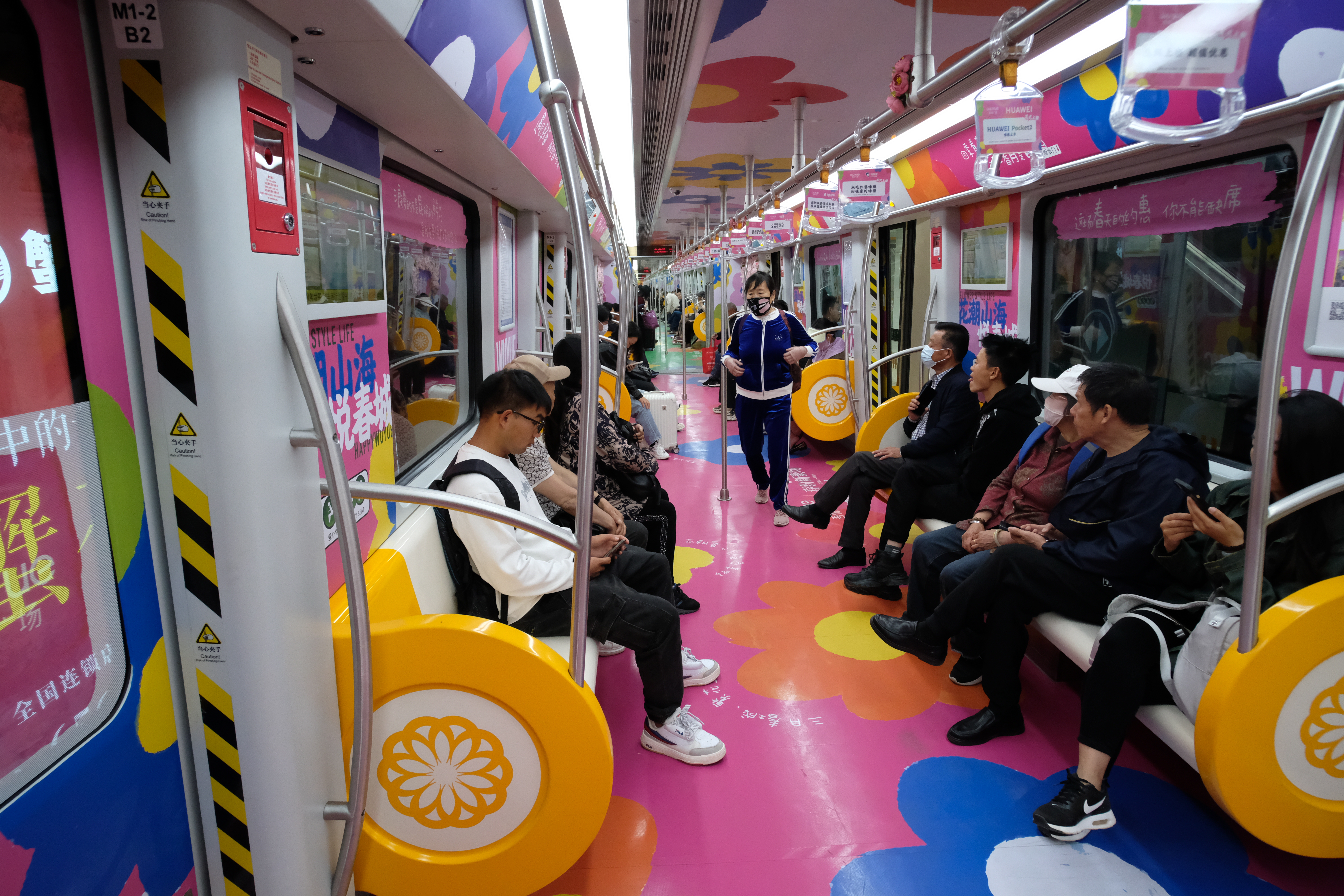 Commuters and visitors enjoy a spring-themed carriage in Kunming on March 27, 2024. /IC