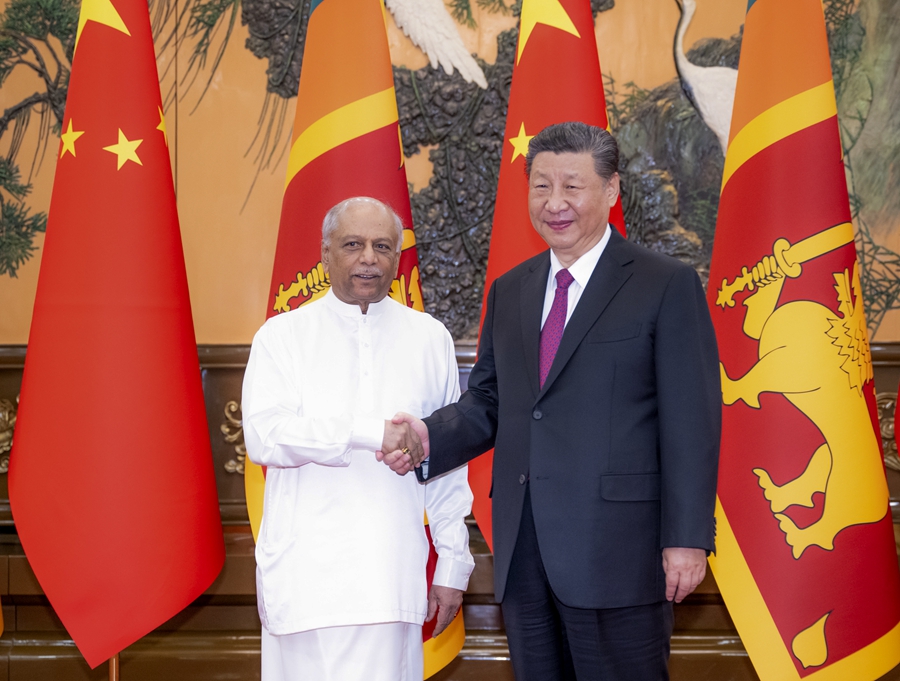 Chinese President Xi Jinping shakes hands with Sri Lankan Prime Minister Dinesh Gunawardena in Beijing, China, March 27, 2024. /Xinhua