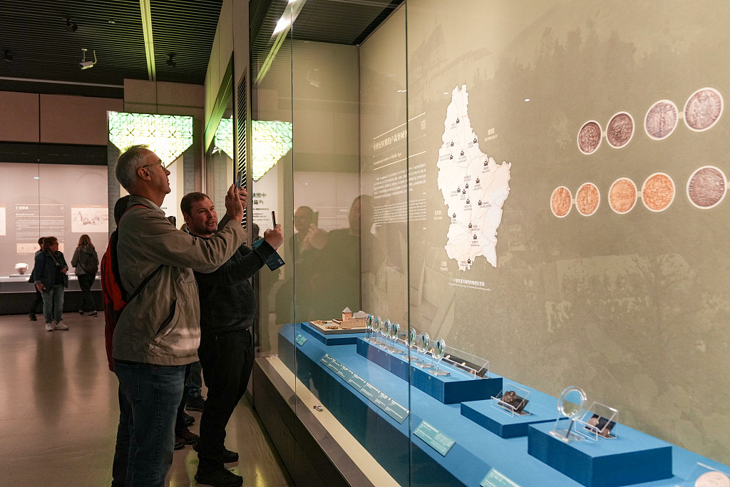 A photo taken on March 28, 2024 shows visitors taking photos of Roman coins on display at the Henan Museum in Zhengzhou. /CFP