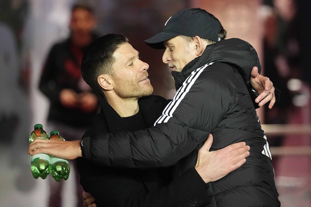 Xabi Alonso (L), manager of Bayer Leverkusen, and Thomas Tuchel, manager of Bayern Munich, hug each other ahead of the clubs' Bundesliga meeting at the BayArena in Leverkusen, Germany, February 10, 2024. /CFP