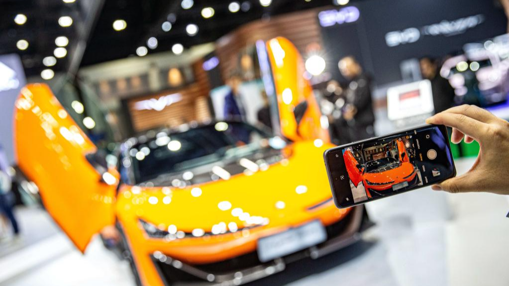 A visitor takes photos of a Hyper SSR at the booth of GAC Aion during the 45th Bangkok International Motor Show in Bangkok, Thailand, March 27, 2024. /Xinhua