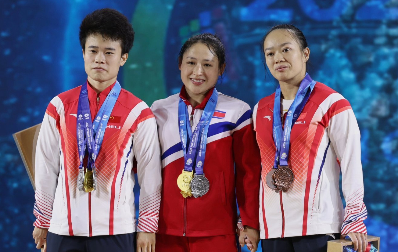 Hou Zhihui (L), Ri Song Gum (C) and Jiang Huihua during the medal ceremony of the women's 49 kg event at the IWF World Cup in Phuket, Thailand, April 1, 2024. /CFP